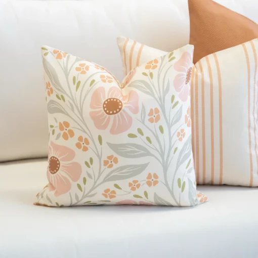 3 outdoor cushions from the Claybourne set sitting on white sofa.