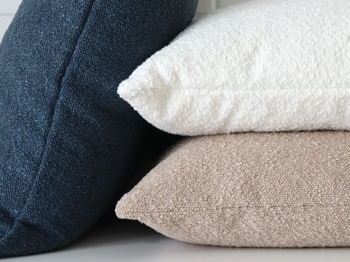 A close up shot showing boucle cushions and their lovely texture and softness.