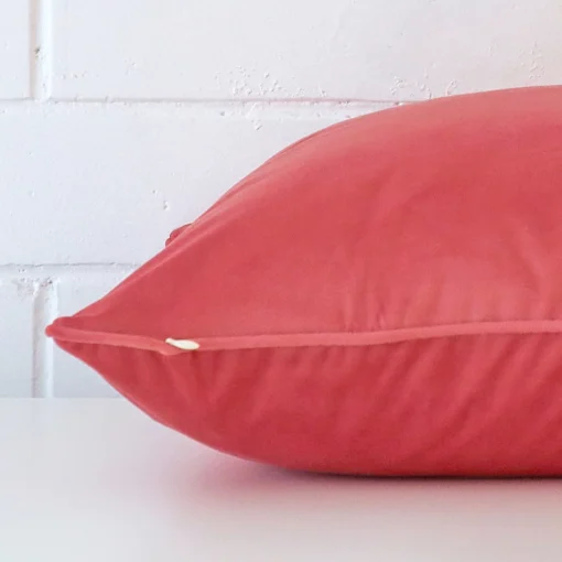 Side image of a velvet large cushion cover. The coral colour is more visible in this up close shot.