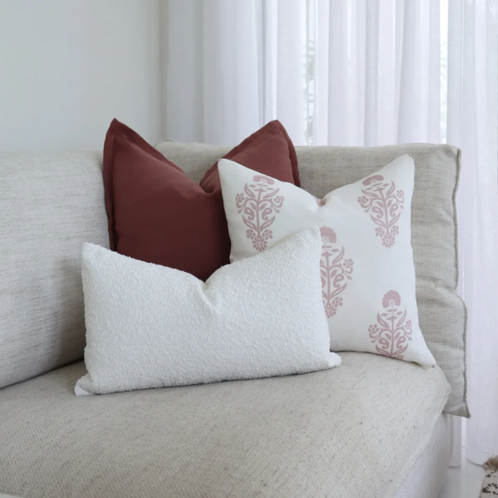 Couch cushions on a corner chair near a window.