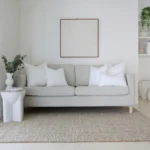 5 cushion inserts made from faux feather are displayed in a bright living room.