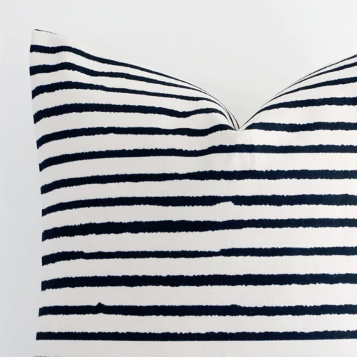 Close range image of striped linen cushion. The large size and linen material can be seen in detail.