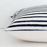 Side angle shot of linen large cushion cover. The striped style are shown along its seams.
