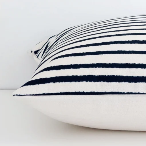 Side angle shot of linen large cushion cover. The striped style are shown along its seams.