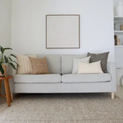 The elegant Essa sofa cushions, a set of 5 designer cushions gives the stylish look of a grey sofa in a living room.