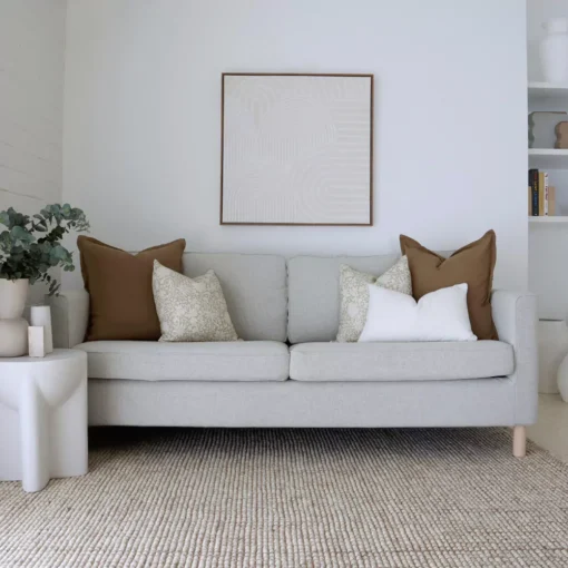 In an airy living room where you will find the Eve sofa cushions set, showcasing 5 sofa cushions arranged neatly.
