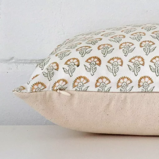A large floral cushion cover is laid flat. This angle shows the side of the designer fabric.