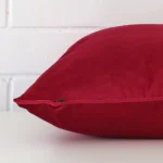 Side angle of fuchsia pink cushion cover that has velvet fabric and a large size.
