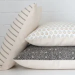 Three handcrafted designer cushions are styled in front of a white background.