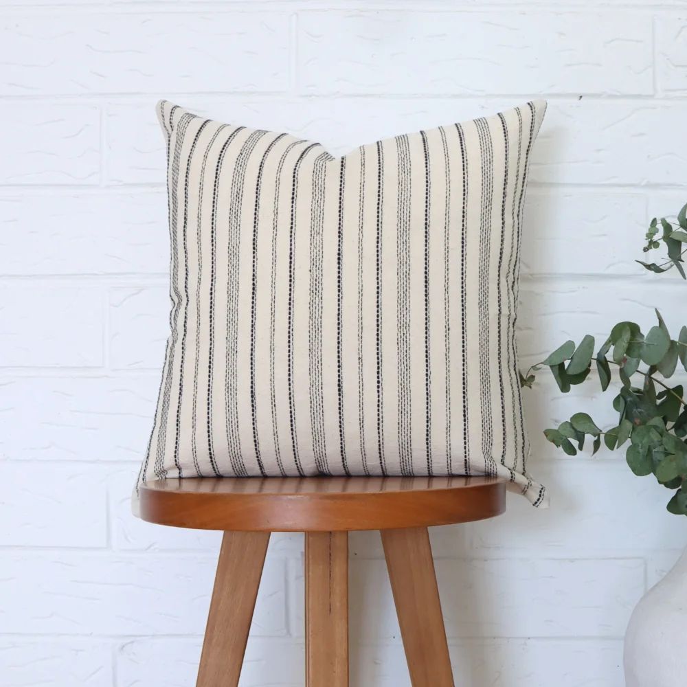 A high chair is shown with a 45x45 cushion cover styled on it.