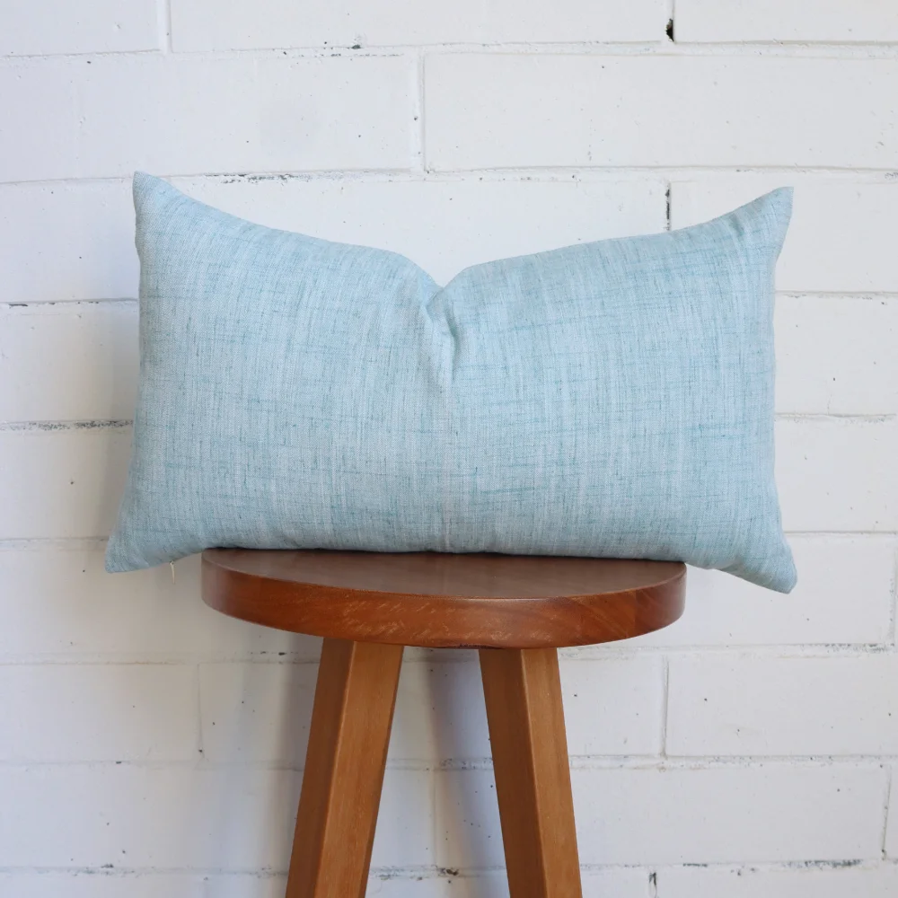 A high chair with a duck egg blue cushion on its top.