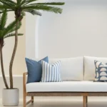 3 horizon blue outdoor cushions are arranged on a white sofa.