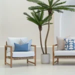 A white sofa with 4 horizon cove outdoor cushions sitting on it.