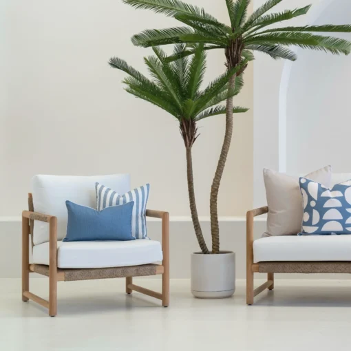 A white sofa with 4 horizon cove outdoor cushions sitting on it.
