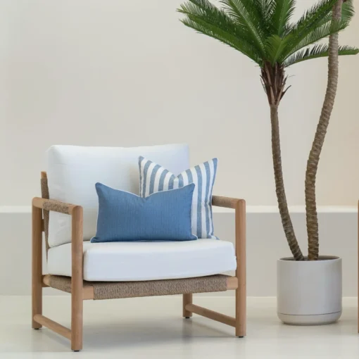 A set of 2 horizon cove outdoor cushions are arranged neatly on an armchair.