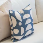 A white sofa styled with 2 horizon cove outdoor cushions.