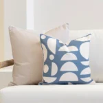 Corner of a white sofa with a set of 2 horizon cove outdoor cushions displayed on it.