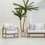 White sofa in an outdoor living room styled with 4 horizon sand outdoor cushions.
