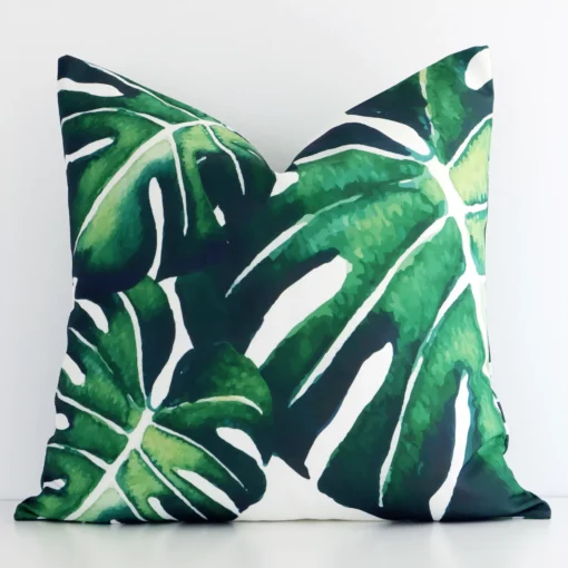 Front view of a square tropical leaf printed cushion. Crafted from a special outdoor material.