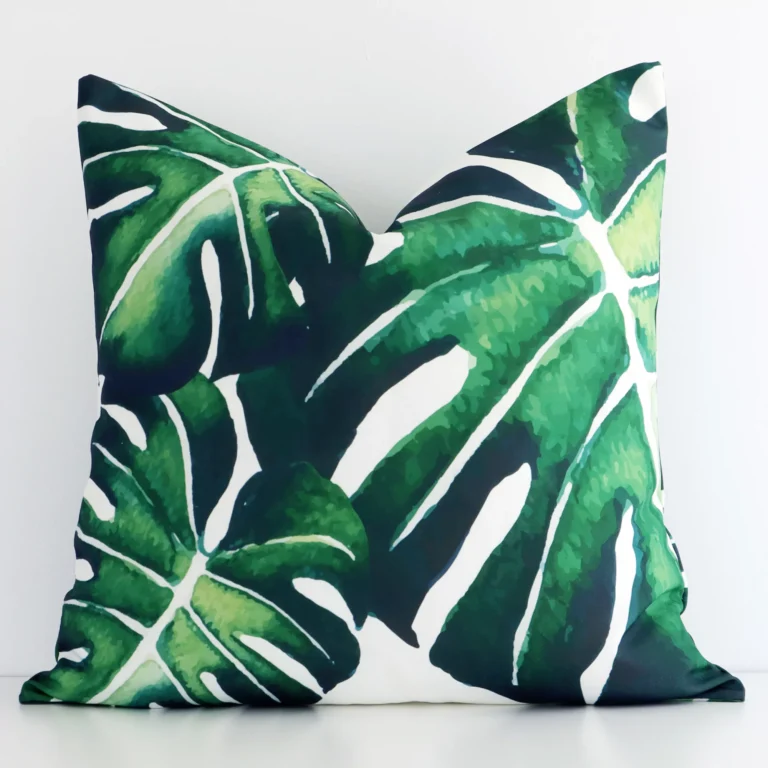Front view of a square tropical leaf printed cushion. Crafted from a special outdoor material.