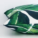 A side view of outdoor tropical cushion that has a square shape.