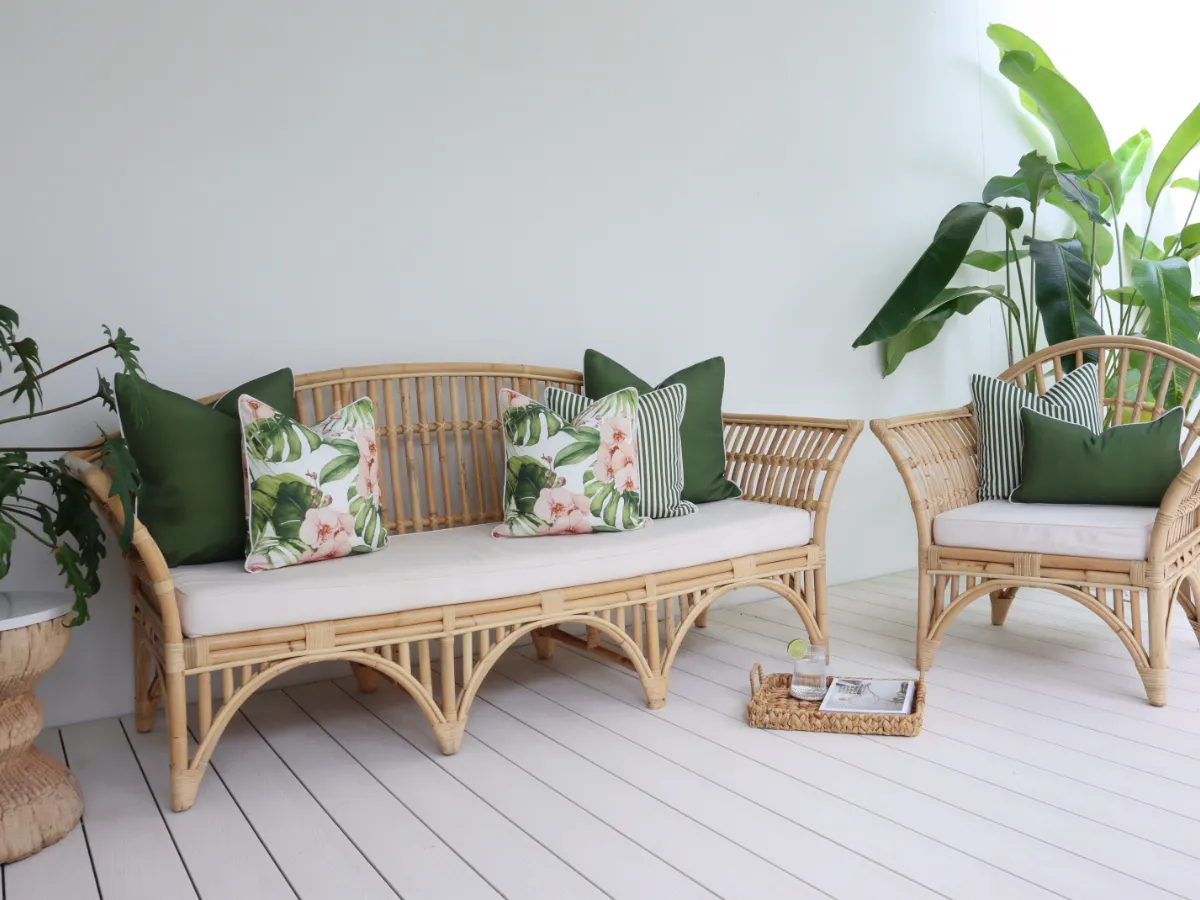 A larger outdoor sofa with the perfect number of cushions on it.