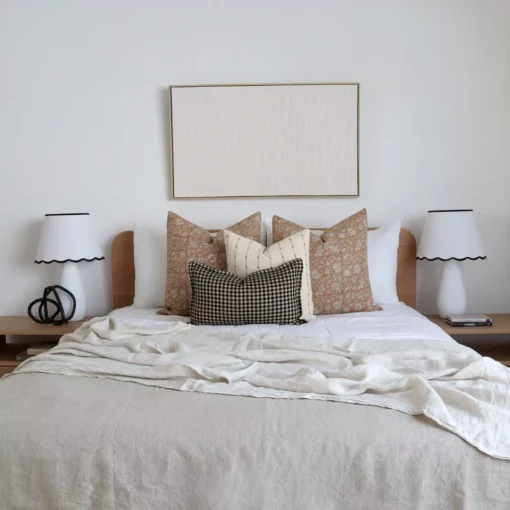 4 designer cushions from the Laurel bed set are elegantly arranged on the bed adding a touch of beauty to the space.