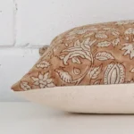 Large floral cushion laying flat. The viewpoint highlights the seams of the designer fabric.