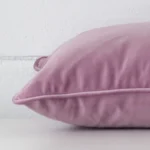 Side angle of lavender cushion cover that has velvet fabric and a rectangle size.