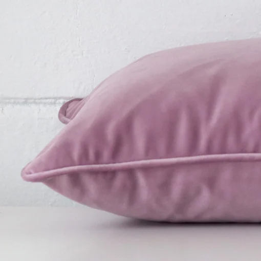 Side angle of lavender cushion cover that has velvet fabric and a rectangle size.