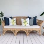 An inviting outdoor lounge area featuring a comfortable seat adorned with 5 beige cushions.