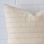 A designer large cushion’s corner has been enlarged in this shot. The detail of the striped design is shown up close.