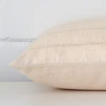 Horizontal edge view of front and back panels of a striped designer cushion in a rectangle size.