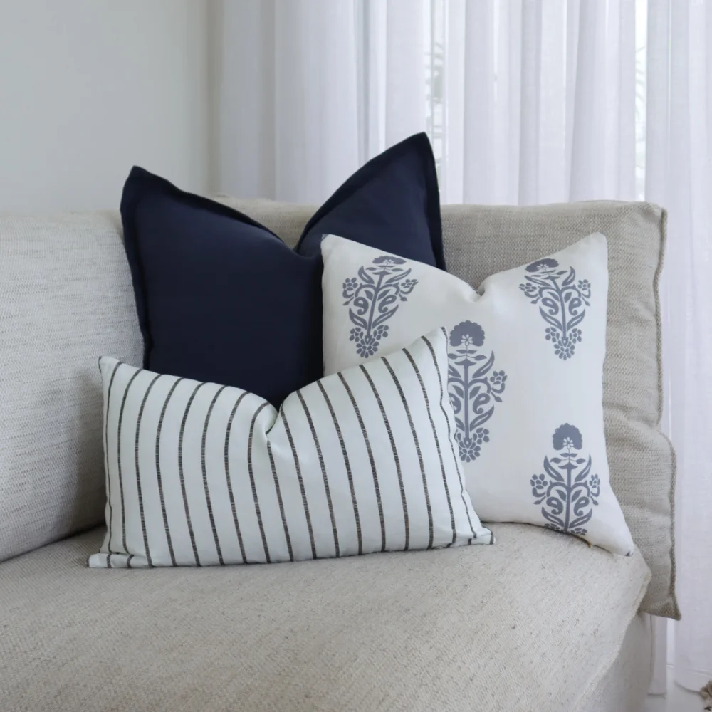 Arranged throw cushions on a light coloured seat.