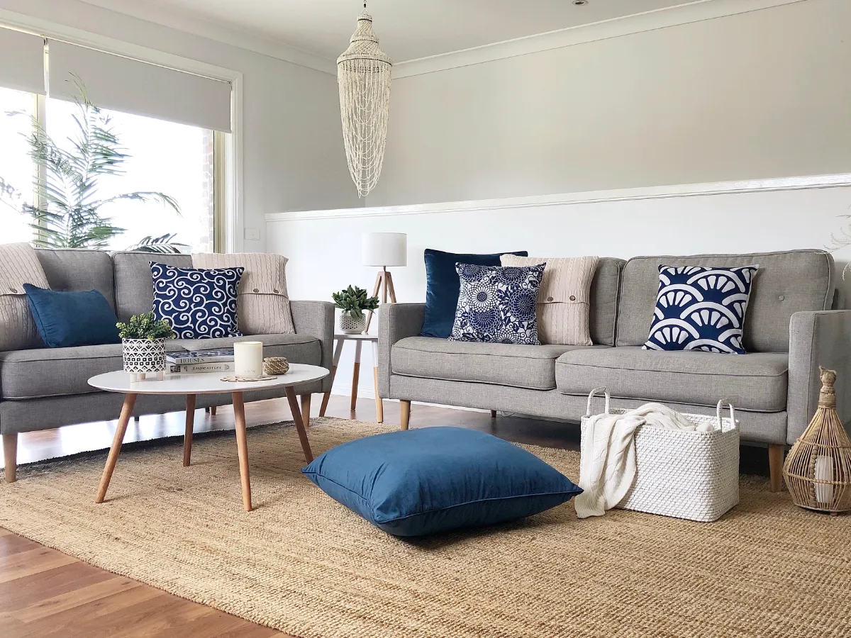 A living room with coastal style colours rich in blue and whites.