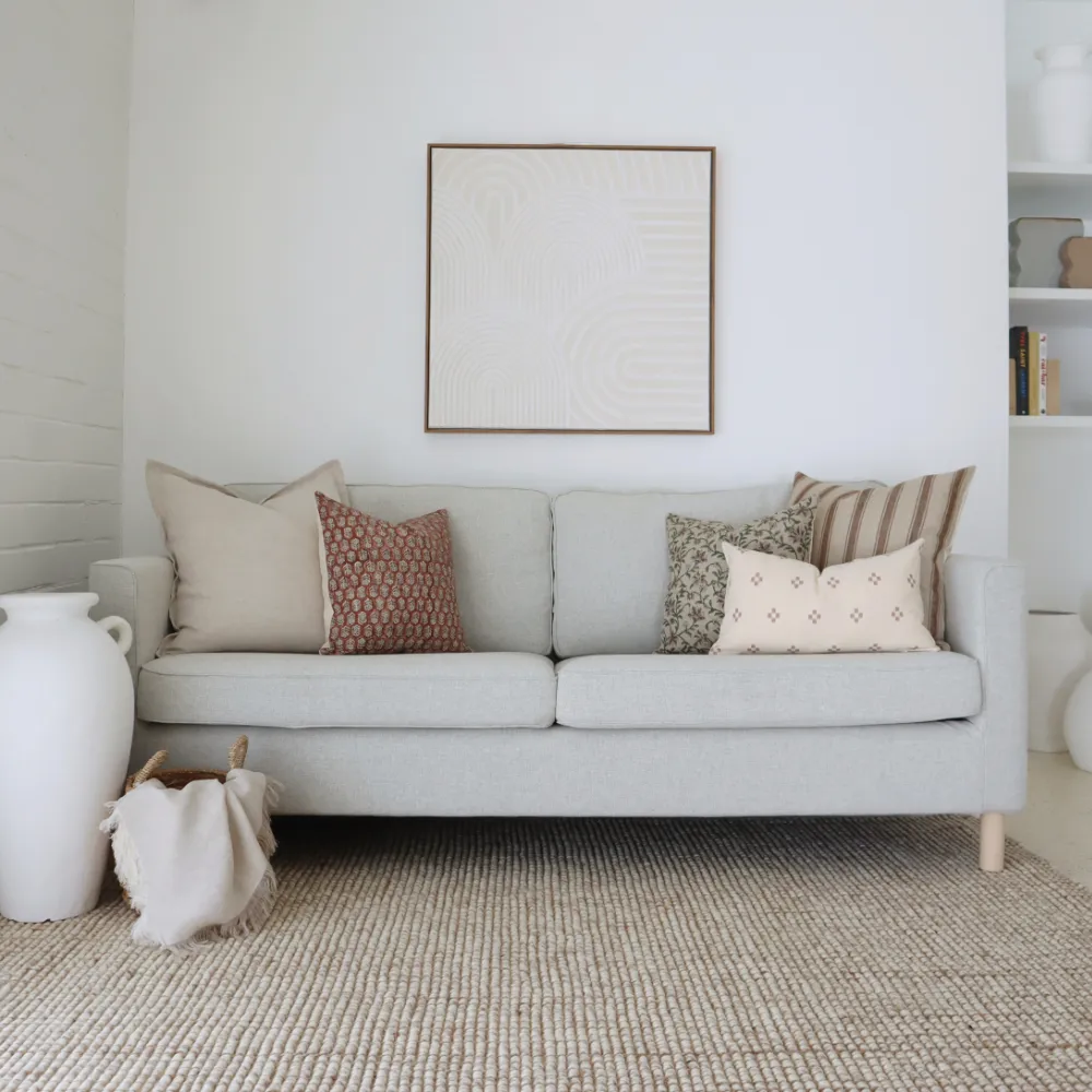 Sofa cushions in a light coloured living room.