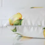 A cushion arranged sideways in front of a wall. The large size and outdoor fabric are shown and the seams are clearly visible.