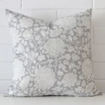 A bold floral linen cushion in a sleek square size with a light blue tone of colour.