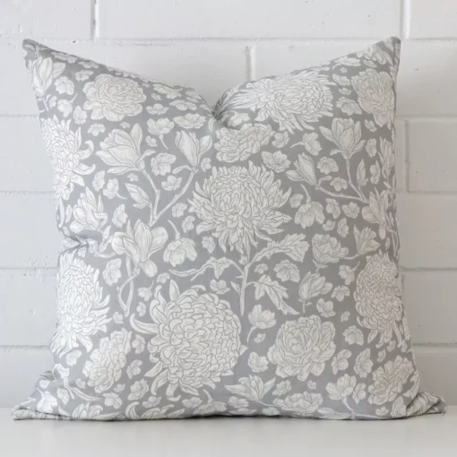A bold floral linen cushion in a sleek square size with a light blue tone of colour.