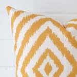 Macro image of a linen square cushion cover. The shot shows the geometric style more thoroughly.
