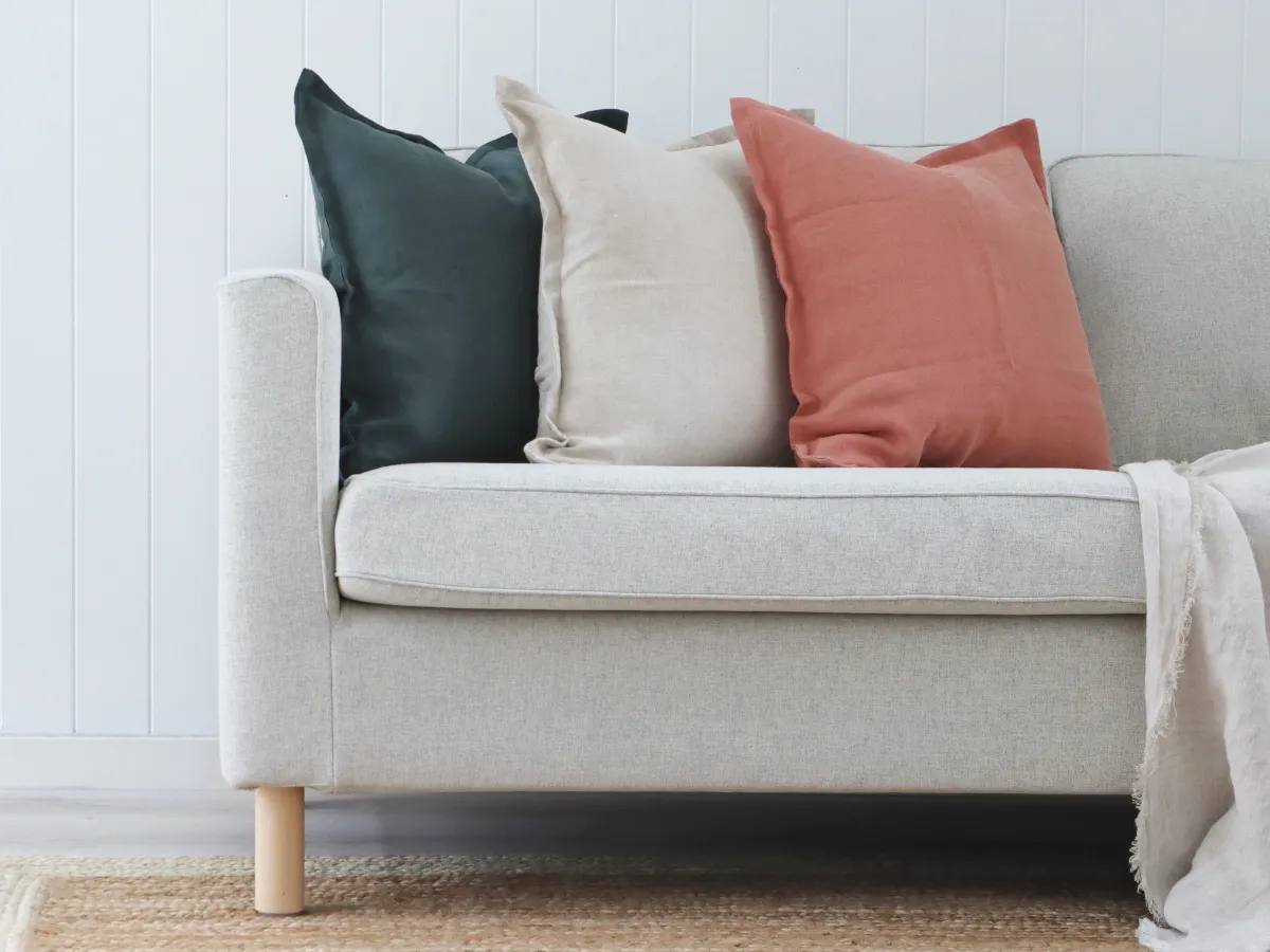 Muted solid colour cushions on a light coloured sofa.