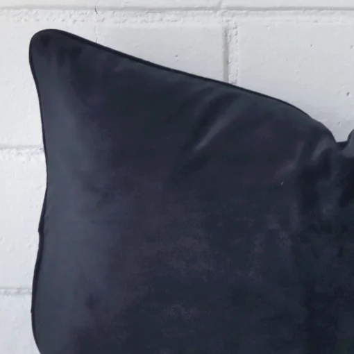 This image shows a navy cushion cover in a rectangle size from a very close range. The velvet material is more clearly shown.
