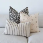 The set of 3 Nellie couch cushions are arranged neatly on a sofa.