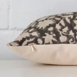Horizontal edge view of front and back panels of a floral designer cushion in a large size.