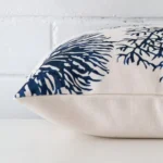 Horizontal edge view of front and back panels of a floral linen cushion in a square size.