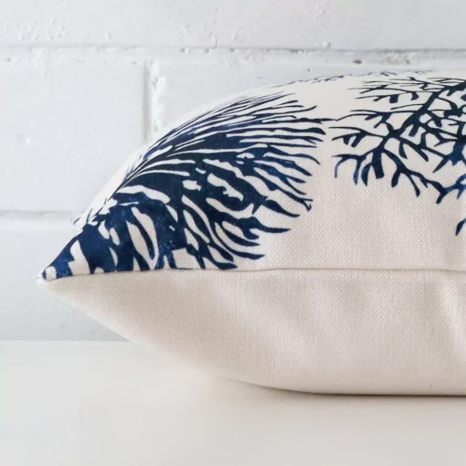 Horizontal edge view of front and back panels of a floral linen cushion in a square size.