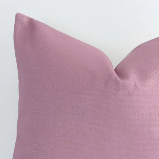 Macro image of a linen square cushion cover. The shot shows the blush hue and solid colour style more thoroughly.