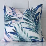A hero shot of a square cushion cover. It is made from a deluxe outdoor fabric and features a pink colour.