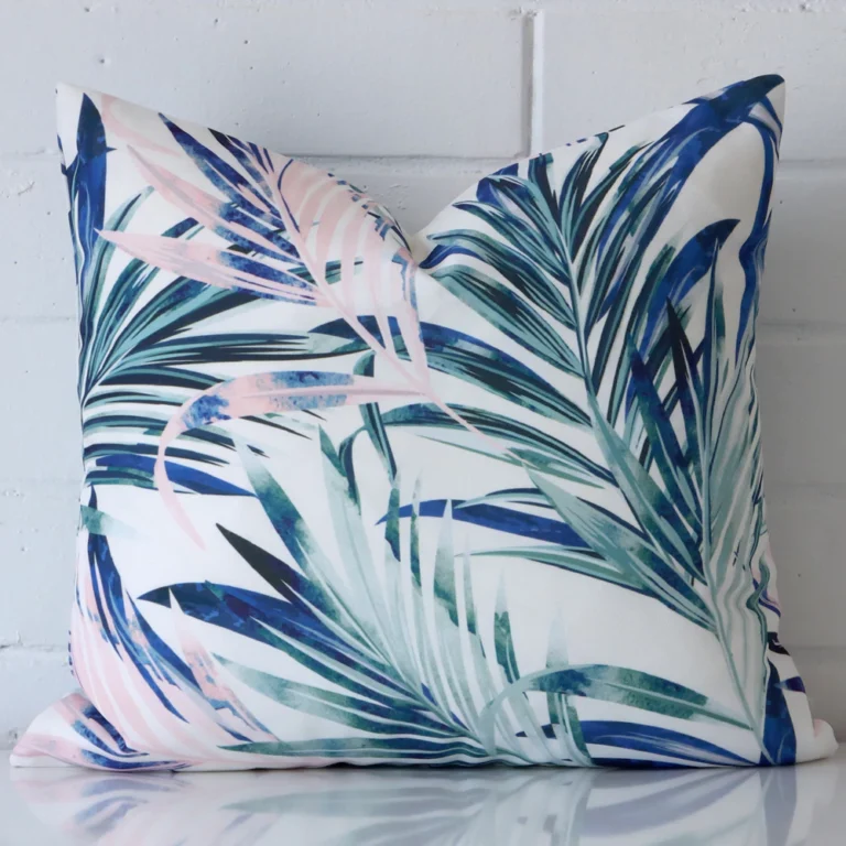 A hero shot of a square cushion cover. It is made from a deluxe outdoor fabric and features a pink colour.