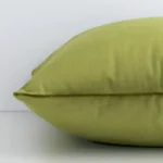 Lateral view of front and back panels of this solid coloured velvet cushion cover in a sqaure size and with olive colouring.